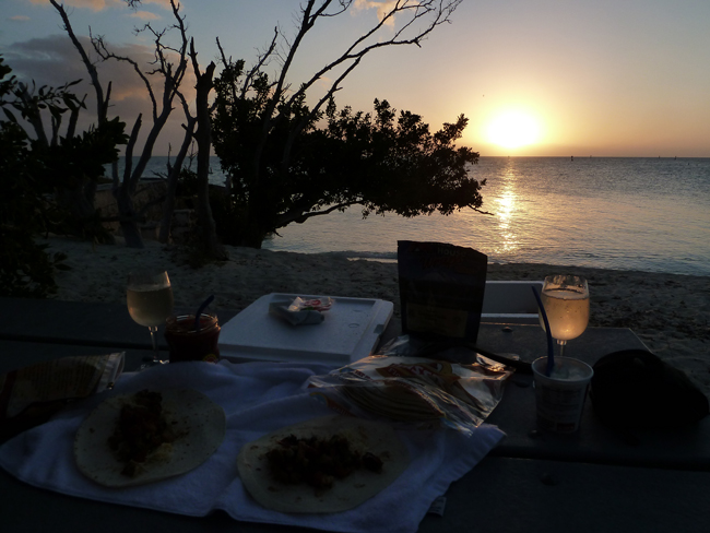 Image of backpacking dinner on the beach at sunset.